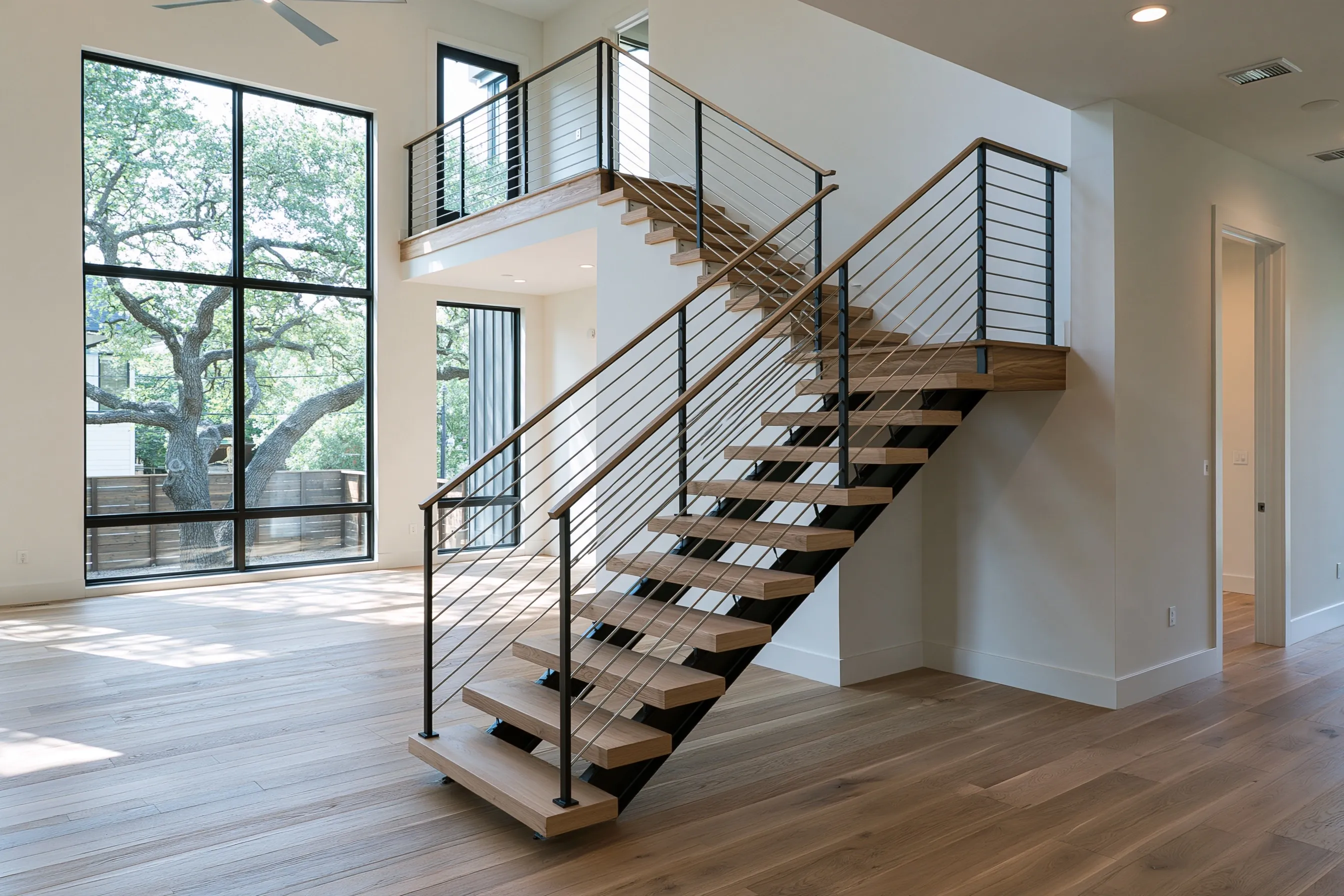 Modern staircase with oak treads and a stainless cable railing